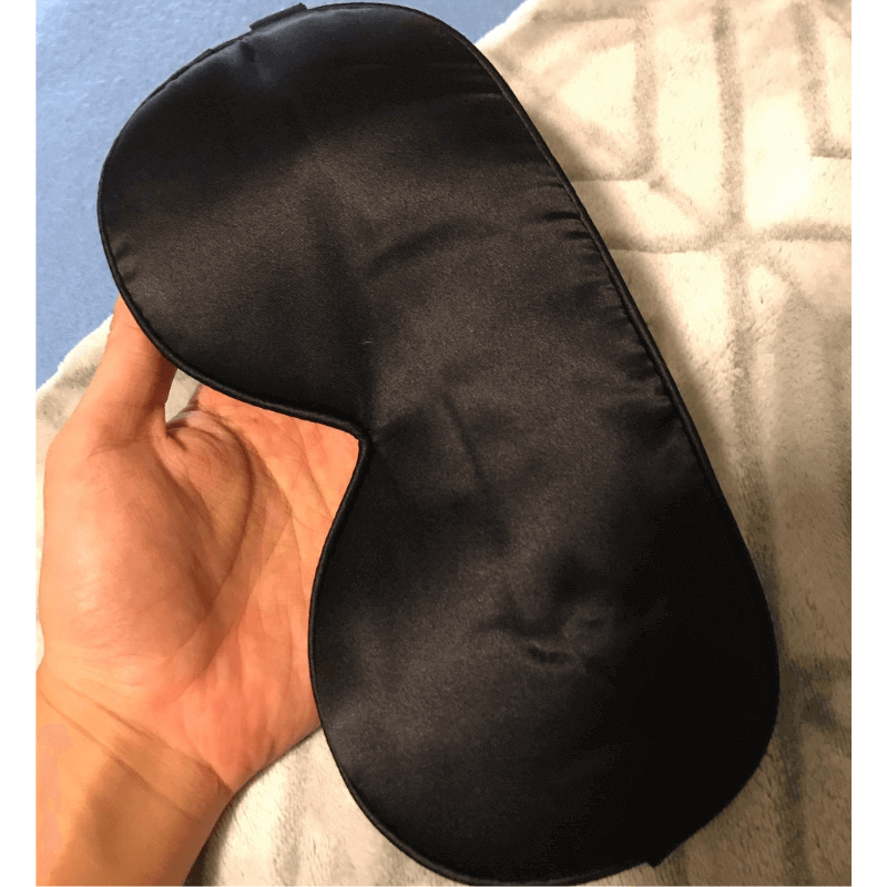 Close-up of the natural silk sleep mask from a side angle, highlighting the contoured design and soft silk fabric.