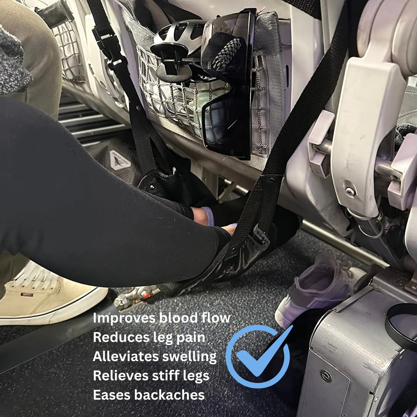 Traveller using airplane footrest on a flight to improve blood flow, reduce leg pain, and relieve swelling and stiffness during long-haul travel.